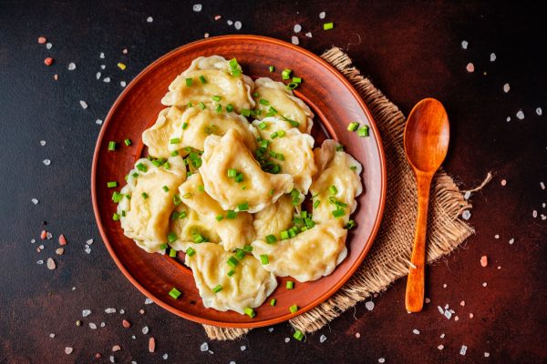 boiled-made-dumplings-with-stuffing-with-oil-green-onions-dark-table-it-can-be-used-as-background (1)_wynik